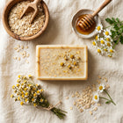 Nivam Oat & Honey soap bar flat-lay with oats and honey on linen