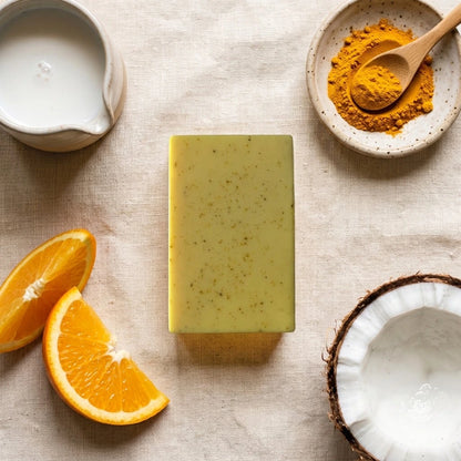 Nivam Turmeric & Coconut Milk soap bar flat-lay with turmeric and coconut on linen